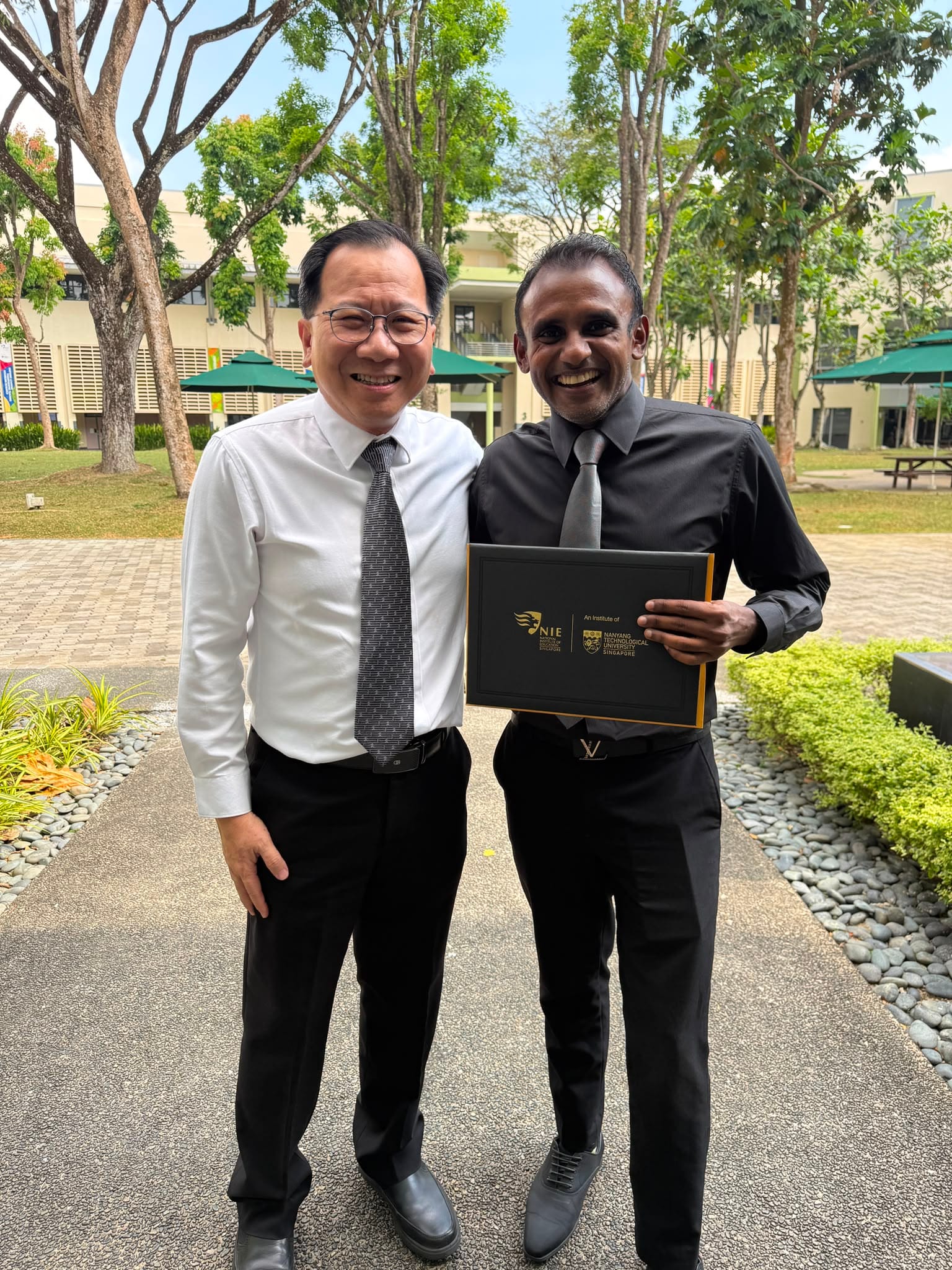 two man stand together with a certificate